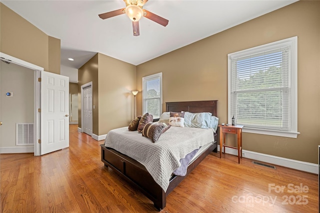bedroom featuring light wood-type flooring, baseboards, and ceiling fan