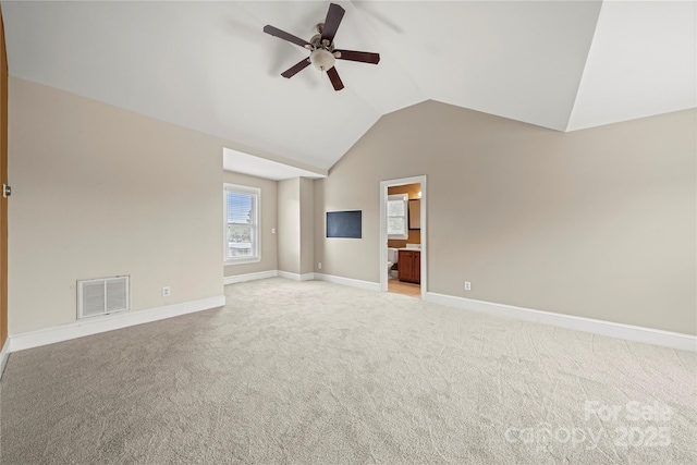 unfurnished living room featuring a ceiling fan, lofted ceiling, light colored carpet, and baseboards