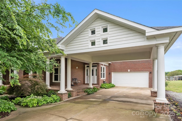 6218 Indian Trail Fairview Rd, Indian Trail, NC 28079 - view of front of home with brick siding, concrete driveway, a porch, and an attached garage