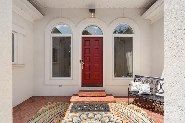 property entrance with stucco siding