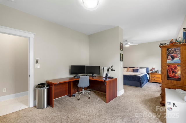 home office featuring carpet, a ceiling fan, and baseboards