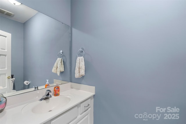 half bathroom with vanity and toilet