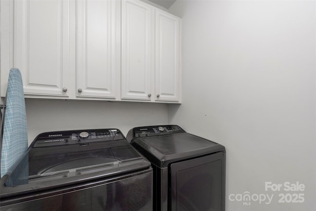 laundry area featuring cabinet space and washer and clothes dryer