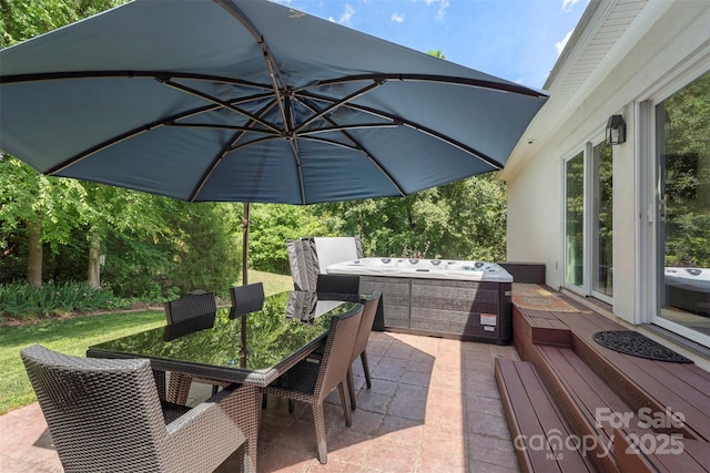 view of patio / terrace featuring a hot tub and outdoor dining space