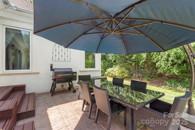 view of patio with outdoor dining space and grilling area