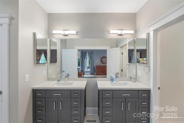 full bathroom featuring two vanities