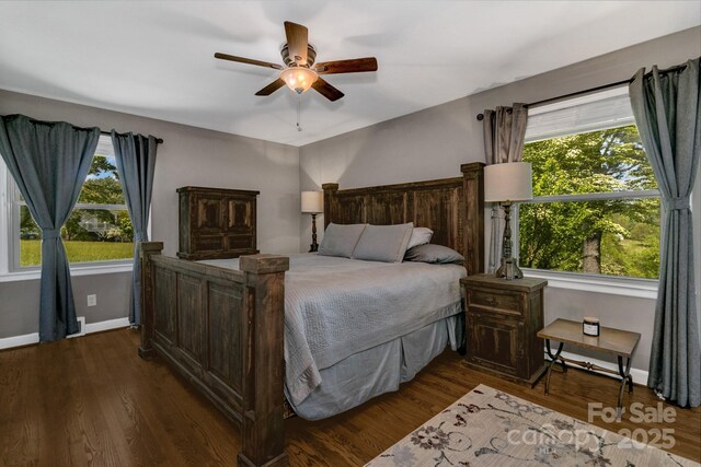 bedroom featuring baseboards, a ceiling fan, and dark wood-type flooring