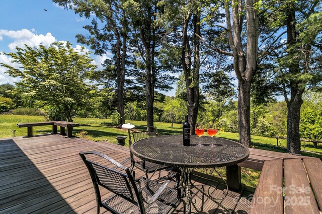 wooden terrace with a lawn