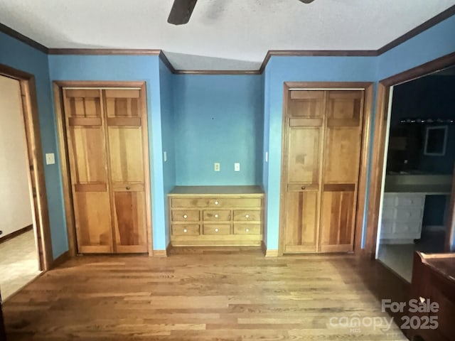 352 Edgemont Dr, Kings Mountain, NC 28086 - unfurnished bedroom with ornamental molding, wood finished floors, and multiple closets