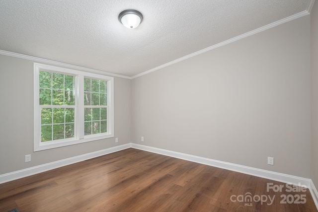 spare room featuring baseboards, dark wood-style flooring, and a textured ceiling