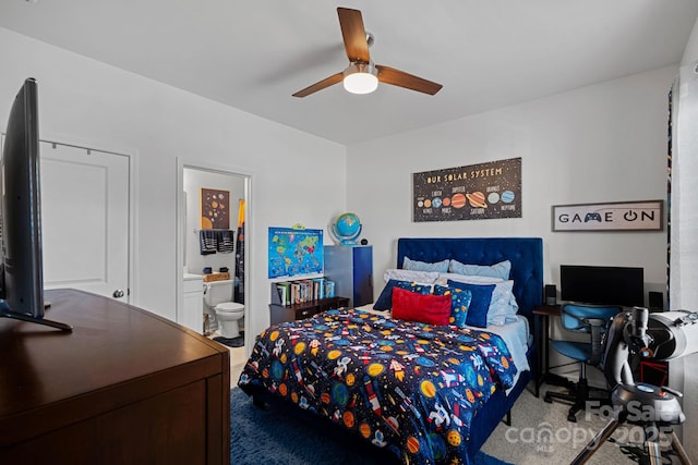 carpeted bedroom with ensuite bathroom and ceiling fan