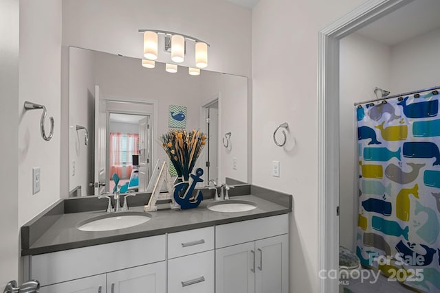 bathroom with double vanity and a shower with shower curtain