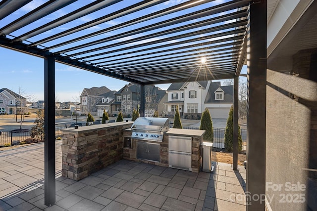 view of patio with area for grilling, grilling area, a residential view, and fence