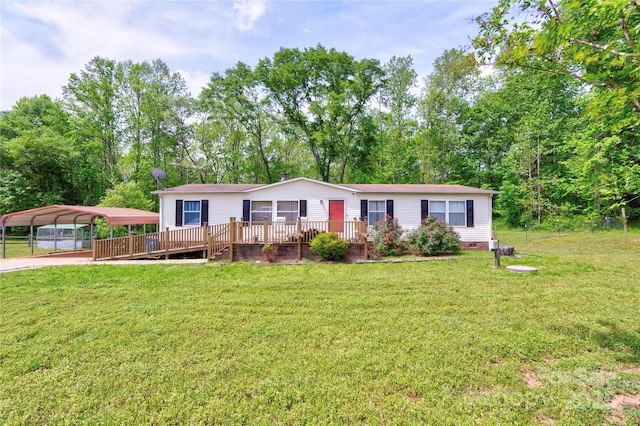 manufactured / mobile home with a front lawn, a detached carport, a wooden deck, and crawl space