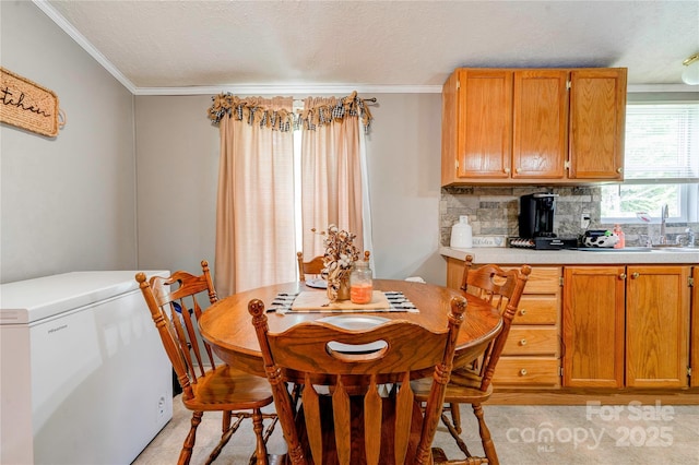 dining area featuring a textured ceiling and crown molding