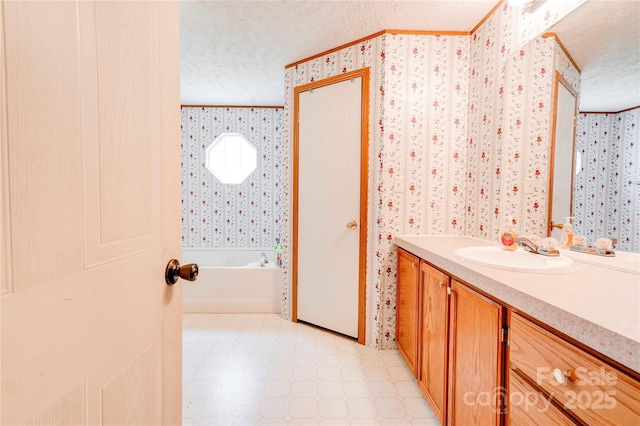 full bath with tile patterned floors, a textured ceiling, ornamental molding, and wallpapered walls
