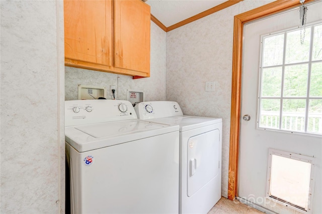 laundry area with light tile patterned floors, washing machine and dryer, wallpapered walls, cabinet space, and ornamental molding