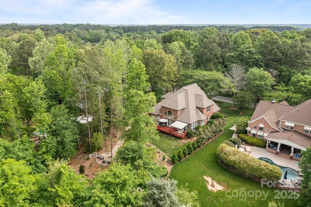 birds eye view of property with a view of trees