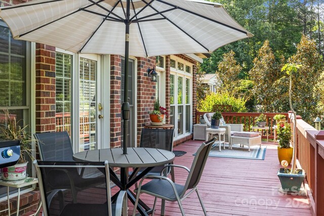 wooden deck featuring outdoor dining space