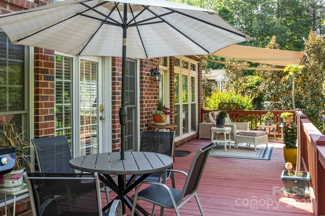 wooden terrace with outdoor dining area