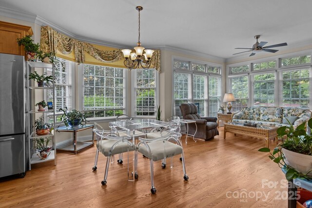 sunroom / solarium featuring an inviting chandelier