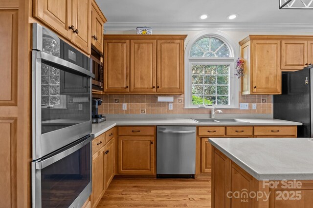 kitchen featuring a sink, appliances with stainless steel finishes, and light countertops