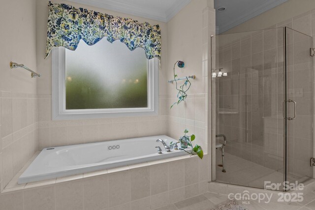 bathroom with a garden tub, crown molding, and a shower stall