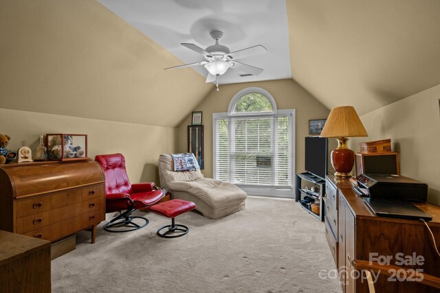 interior space featuring a ceiling fan, carpet flooring, and lofted ceiling