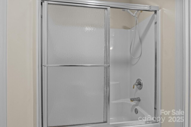 full bathroom featuring shower / bath combination with glass door
