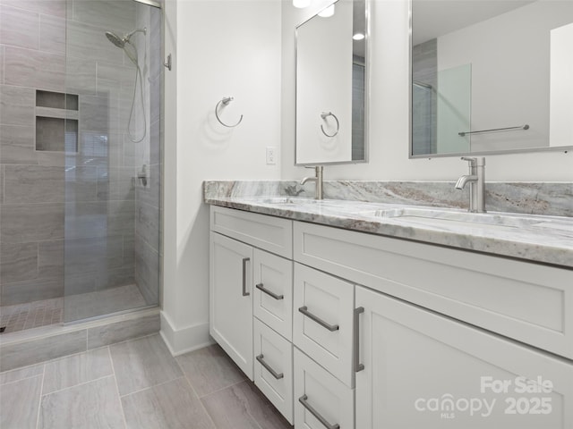 23 Heartleaf Cir, Arden, NC 28704 - full bathroom with a tile shower, double vanity, and baseboards