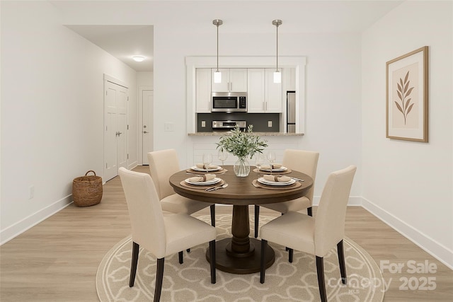 23 Heartleaf Cir, Arden, NC 28704 - dining area with light wood-type flooring and baseboards