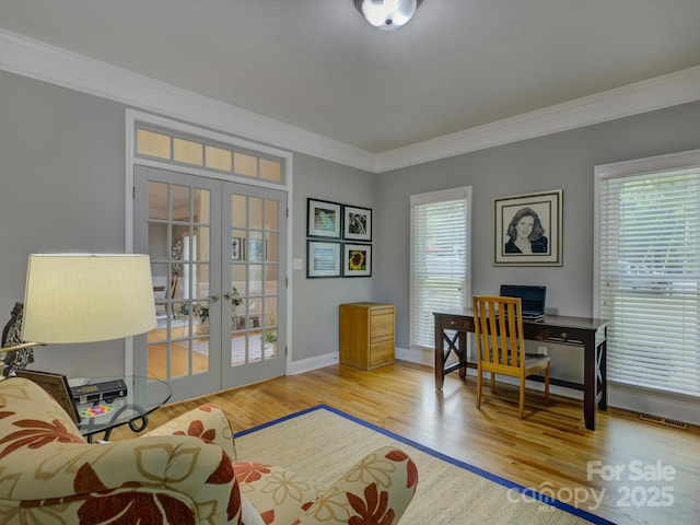 interior space with ornamental molding, french doors, wood finished floors, and plenty of natural light