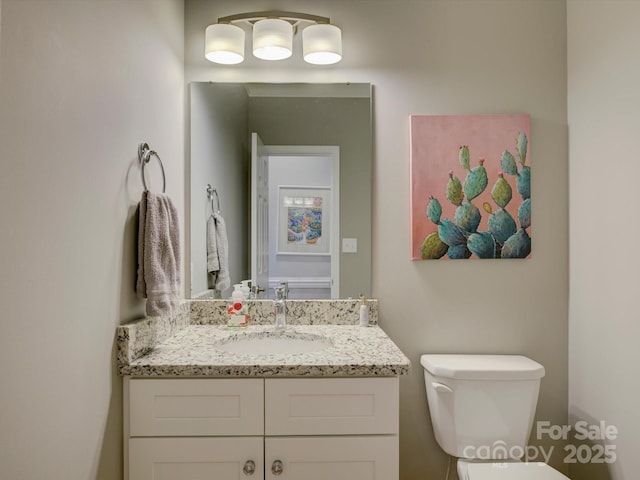 bathroom featuring toilet and vanity