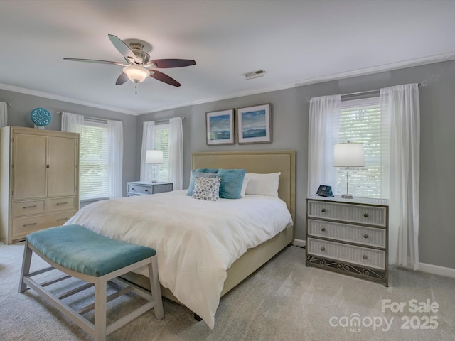 bedroom with ornamental molding, baseboards, visible vents, and light colored carpet