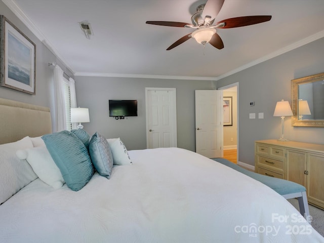 bedroom featuring ceiling fan, baseboards, and ornamental molding