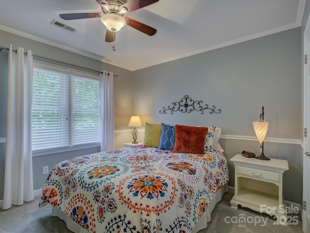bedroom with carpet floors, visible vents, and crown molding