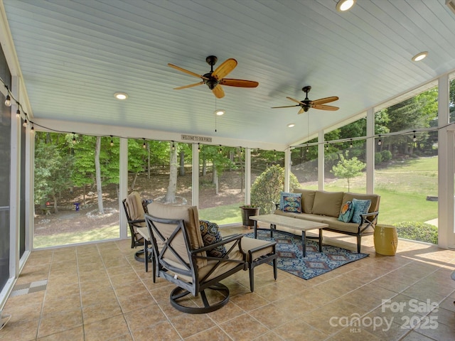 sunroom / solarium with ceiling fan and an outdoor hangout area