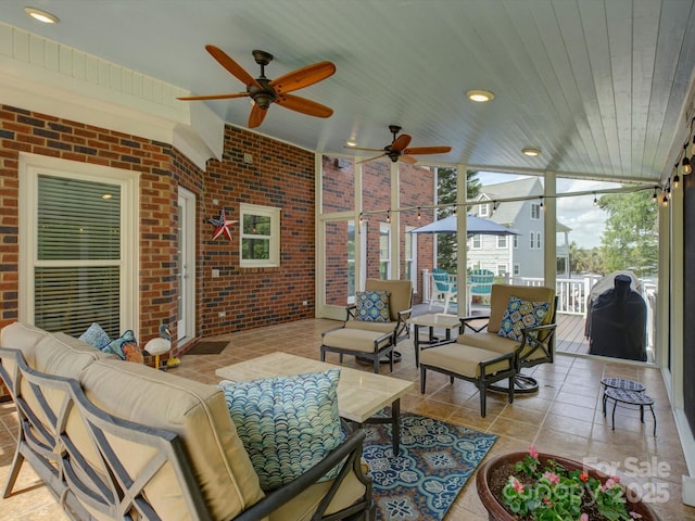 interior space featuring an outdoor hangout area, a ceiling fan, and area for grilling