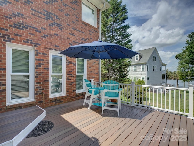 wooden terrace with outdoor dining space