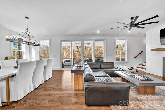 living area with crown molding and wood finished floors