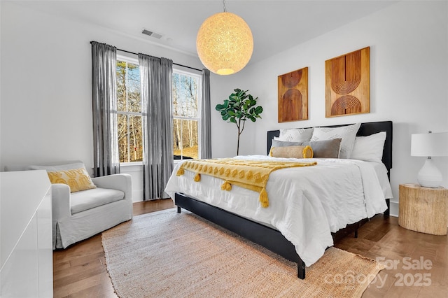 bedroom with wood finished floors and visible vents