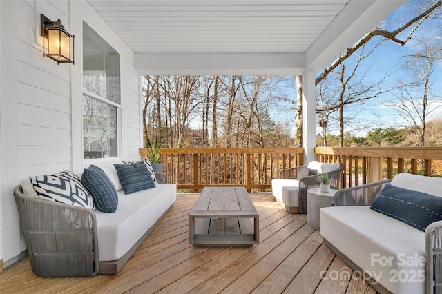 wooden terrace with an outdoor hangout area