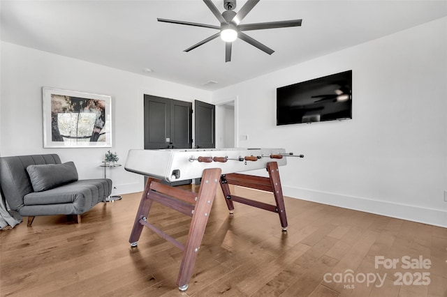 office area with light wood-type flooring, baseboards, and ceiling fan