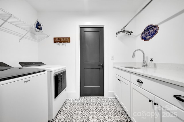laundry room with a sink, cabinet space, and washing machine and dryer