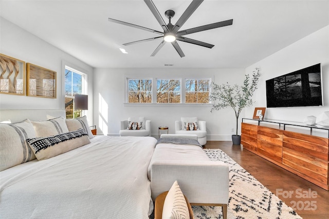 bedroom with baseboards, a ceiling fan, dark wood-type flooring, and visible vents