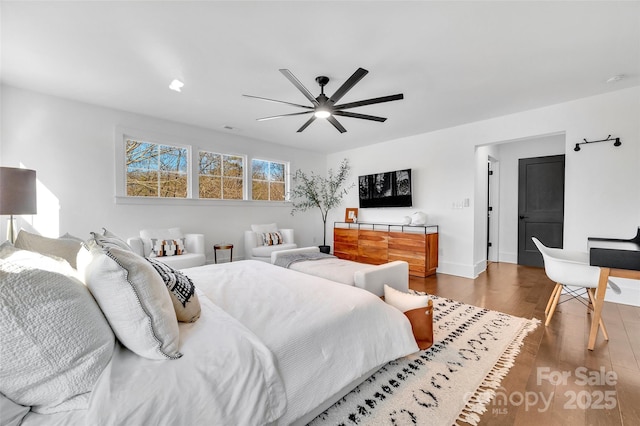 bedroom with baseboards, dark wood finished floors, and ceiling fan