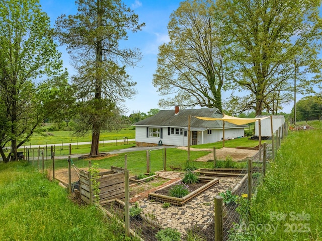 view of yard with fence and a garden