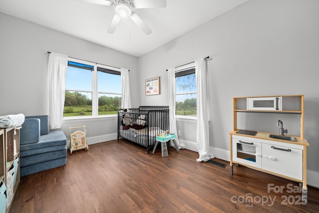 sitting room with visible vents, ceiling fan, wood finished floors, and baseboards