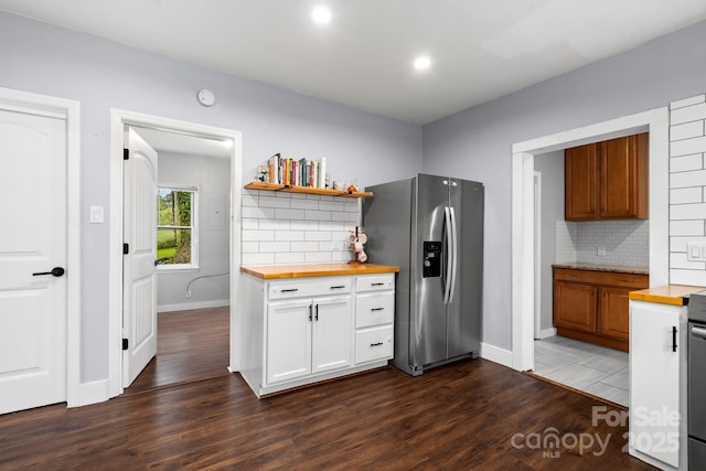 kitchen featuring wood counters, tasteful backsplash, stainless steel refrigerator with ice dispenser, and dark wood-type flooring