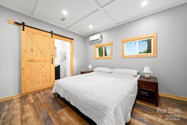 bedroom featuring baseboards, a barn door, a wall mounted air conditioner, dark wood-style floors, and visible vents